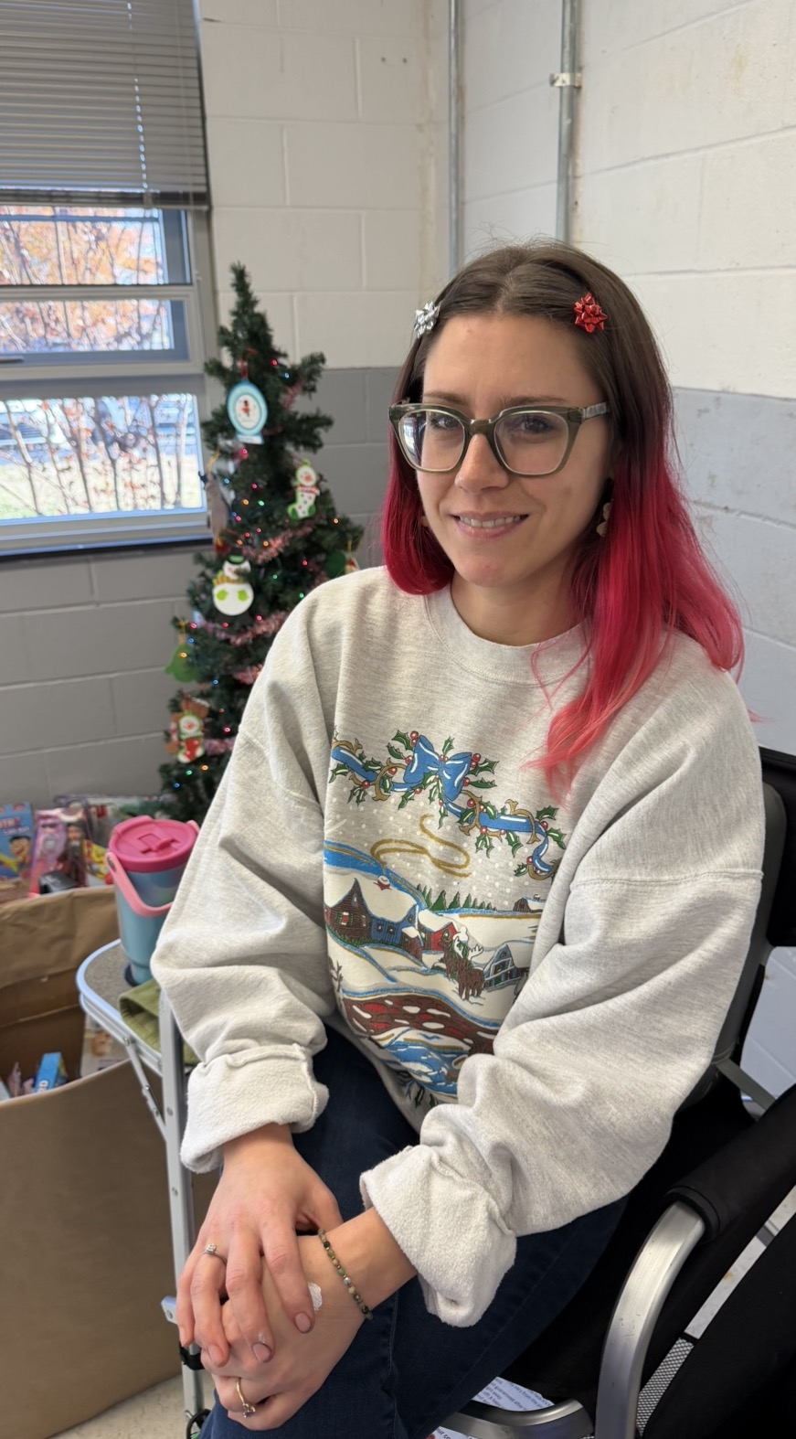 Sadie smiling warmly at a holiday event